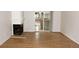 Bright living room featuring wood flooring, a fireplace, and sliding glass doors to a private patio at 922 S Walden St # 101, Aurora, CO 80017