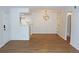 Living room with wood flooring, a modern light fixture, and open access to the kitchen at 922 S Walden St # 101, Aurora, CO 80017