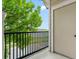 Relax on this outdoor balcony with lush green tree views and black metal railing at 1631 Egret Way, Superior, CO 80027