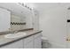 Bathroom features a granite vanity, a shower/tub combo, and sleek black and white decorative tile at 1631 Egret Way, Superior, CO 80027