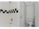 The bathroom features white tiling with decorative square accents along the tub and a toilet at 1631 Egret Way, Superior, CO 80027
