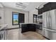 Amenity kitchen features black cabinets, stainless steel appliances, granite countertops, and hardwood floors at 1631 Egret Way, Superior, CO 80027