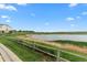 Relaxing pond view with grassy shoreline and a glimpse of the building at 1631 Egret Way, Superior, CO 80027