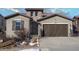 Nice two-story house with a landscaped front yard and a two-car garage at 2189 S Nile St, Lakewood, CO 80228