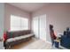Versatile room with light wood floors, a large window, a futon, and plenty of natural light at 8707 E Florida Ave # 410, Denver, CO 80247