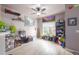Open-concept living room with large windows, light wood floors, and quirky decor at 8707 E Florida Ave # 410, Denver, CO 80247
