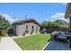 View of garage, grassy backyard, small playhouse and outdoor seating at 4180 Ames St, Denver, CO 80212