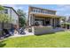 Backyard patio area featuring a built-in grill, outdoor seating and adjacent grass at 4180 Ames St, Denver, CO 80212