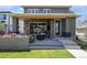 Backyard featuring outdoor living with a patio, tv, flower planters and grass at 4180 Ames St, Denver, CO 80212
