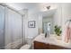 Bathroom featuring a shower with curtain, a sleek vanity, and modern mirror and lighting at 4180 Ames St, Denver, CO 80212