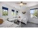 Bedroom with two twin beds, white furniture, and natural light from multiple windows at 4180 Ames St, Denver, CO 80212