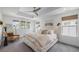 Serene primary bedroom with a tray ceiling, multiple windows, and neutral decor at 4180 Ames St, Denver, CO 80212