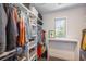 Walk-in closet offering ample shelving, hanging space, and a natural light from a window at 4180 Ames St, Denver, CO 80212