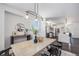 Elegant dining room with modern lighting and a view into the kitchen at 4180 Ames St, Denver, CO 80212