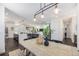 Open dining area connected to the kitchen and living spaces, featuring a modern chandelier and hardwood floors at 4180 Ames St, Denver, CO 80212