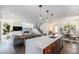 Open-concept kitchen featuring an island with seating, stainless appliances, and living room views at 4180 Ames St, Denver, CO 80212