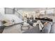 Open concept living room with sleek staircase and modern finishes, flowing into the dining and kitchen area at 4180 Ames St, Denver, CO 80212