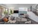 Comfortable living room with stylish fireplace, large TV, and a view of the backyard through sliding glass doors at 4180 Ames St, Denver, CO 80212