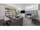 Bright living room featuring a cozy fireplace, a large sectional sofa, and access to the outdoors through sliding glass doors at 4180 Ames St, Denver, CO 80212