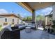 Outdoor patio area with comfortable sectional seating under a covered porch, perfect for entertaining at 4180 Ames St, Denver, CO 80212