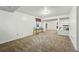 Open basement area with neutral carpet, a window for light, and a bar at 7314 W Walker Pl, Littleton, CO 80123