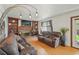 Comfortable living room with a brick fireplace, built-in shelving, and a cozy seating area at 7314 W Walker Pl, Littleton, CO 80123