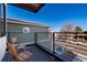 A charming balcony shows wood chairs and an unobstructed view of the neighborhood street at 9742 Fairwood St, Littleton, CO 80125