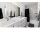 Bright and modern bathroom with a double sink vanity and bathtub with shower at 9742 Fairwood St, Littleton, CO 80125