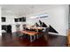 Dining room with modern light fixture, mountain-themed wall art, hardwood floors, and an adjoining kitchen at 9742 Fairwood St, Littleton, CO 80125