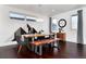 Dining room with modern light fixture, mountain-themed wall art, hardwood floors, and a wood bench at 9742 Fairwood St, Littleton, CO 80125