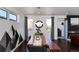 A dining room featuring a wooden table with bench seating, modern art accents, and ample natural light at 9742 Fairwood St, Littleton, CO 80125