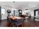 Modern dining room with hardwood floors, contemporary lighting, and a stylish, live-edge wood table at 9742 Fairwood St, Littleton, CO 80125