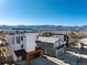 Exterior home elevation showcasing a modern multi-story residence with rooftop deck and mountain views at 9742 Fairwood St, Littleton, CO 80125