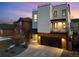 Modern three-story home with a rooftop deck and stone and white stucco facade with a two car garage at 9742 Fairwood St, Littleton, CO 80125