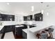 Modern kitchen with sleek black cabinets, white countertops, and stainless steel appliances with ample counter space at 9742 Fairwood St, Littleton, CO 80125