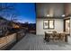 An outdoor covered dining area with seating and access to the home's interior is perfect for entertaining at 9742 Fairwood St, Littleton, CO 80125