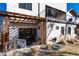 A backyard patio features a hot tub and an outdoor living space with a pergola and string lights at 9742 Fairwood St, Littleton, CO 80125