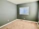 Simple bedroom with neutral carpet, gray walls and a bright window offering ample natural light at 2561 W Dartmouth Ave, Denver, CO 80236