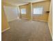 Spacious bedroom with plush carpeting, two windows and ample closet space at 2561 W Dartmouth Ave, Denver, CO 80236