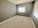 Cozy carpeted bedroom with neutral walls and natural light at 2561 W Dartmouth Ave, Denver, CO 80236