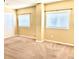 Bright bedroom with neutral carpet and a large window offering ample natural light and a view of the outdoors at 2561 W Dartmouth Ave, Denver, CO 80236