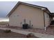 Side view showcasing the home's light beige siding and landscaping at 47855 E 88Th Ave, Bennett, CO 80102