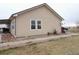 Side view of the home, showing additional windows and landscaping at 47855 E 88Th Ave, Bennett, CO 80102