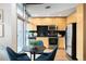 Modern kitchen with light wood cabinets, stainless steel appliances, and black tile backsplash at 1700 Bassett St # 505, Denver, CO 80202