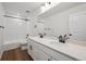 The bathroom features double vanity, wood-style floors, and shower-tub combo at 24708 E 40Th Ave, Aurora, CO 80019