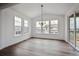 Dining room with large windows, a modern chandelier, and sliding doors to the backyard at 24708 E 40Th Ave, Aurora, CO 80019