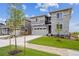Beautiful two-story home with gray siding, stone accents, well-manicured lawn, and a two car garage at 24708 E 40Th Ave, Aurora, CO 80019