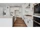 Modern kitchen with stainless steel appliances, white cabinets, and a large island with seating at 24708 E 40Th Ave, Aurora, CO 80019