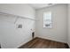 White laundry room with wire shelving, wood-style floors, a window and hookups ready for a washer and dryer at 24708 E 40Th Ave, Aurora, CO 80019