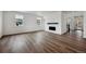 Open-concept living room with hardwood floors, a modern fireplace, and large windows at 24708 E 40Th Ave, Aurora, CO 80019